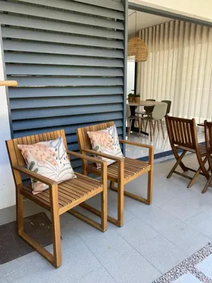 two chairs and a glass table on a patio at Bordal Houses Casa da Areia in Porto Santo