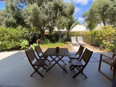 a wooden table and four chairs on a patio at Bordal Houses Casa da Areia in Porto Santo