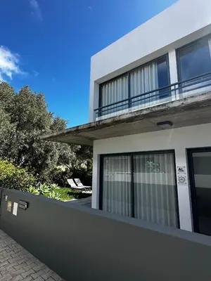 a white house with a fence in front of it at Bordal Houses Casa da Areia in Porto Santo