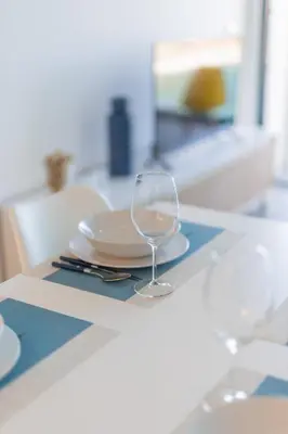 a wine glass sitting on a table with a plate at FLH Fantastic Ocean View with Balcony in Santa Cruz