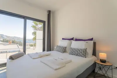 a bedroom with a large white bed with a large window at FLH Fantastic Ocean View with Balcony in Santa Cruz
