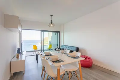 a dining room with a table and chairs at FLH Fantastic Ocean View with Balcony in Santa Cruz