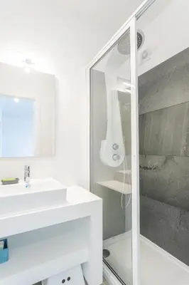 a white bathroom with a sink and a shower at FLH Fantastic Ocean View with Balcony in Santa Cruz