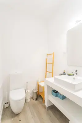 a white bathroom with a toilet and a sink at FLH Fantastic Ocean View with Balcony in Santa Cruz