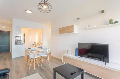 a living room with a dining room table and a tv at FLH Fantastic Ocean View with Balcony in Santa Cruz