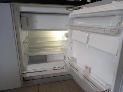 an empty refrigerator with its door open in a kitchen at BELCH1952 in Lagos