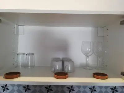 a shelf with wine glasses and other items on it at BELCH1952 in Lagos