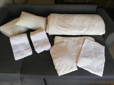 a bed with white sheets and pillows on it at BELCH1952 in Lagos