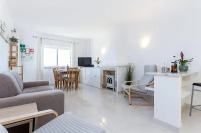 a living room with a couch and a table at Apartamento Salema 33 in Salema