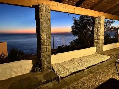 a view of the ocean from a window with a mattress at Cozy Sea View House Fajã da Ovelha in Calheta