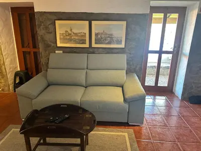 a living room with a couch and a table at Cozy Sea View House Fajã da Ovelha in Calheta