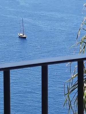 a sailboat in the water with a boat at Zeza´s Sky in Calheta