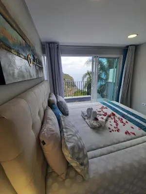 a living room with a couch and a large window at Zeza´s Sky in Calheta
