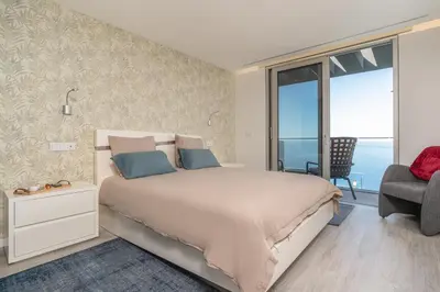 a bedroom with a bed with a view of the ocean at Sonho do Oceano in Ribeira Brava