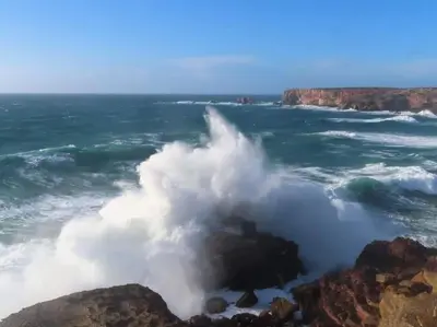 a wave crashing on the rocks in the ocean at Coureladaltura in Aljezur