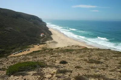 a view of a beach with a group of people at Coureladaltura in Aljezur