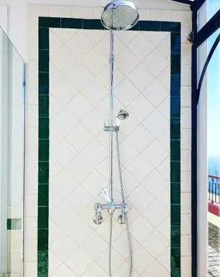 a shower with a glass door in a bathroom at Quinta do Cabouco in Ribeira Brava