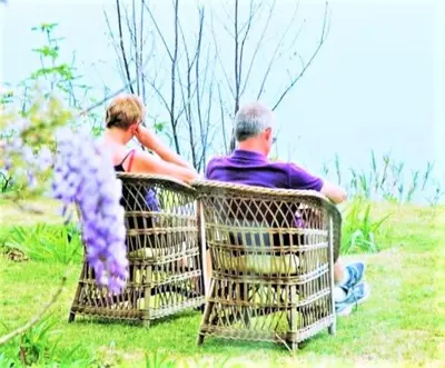 a man and a woman sitting in wicker chairs at Quinta do Cabouco in Ribeira Brava