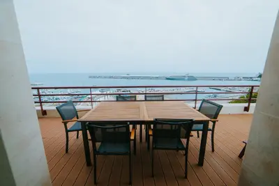 a table and chairs on a balcony with a view of the ocean at Rooftop Marina l by Madeira Best Apartments in Funchal