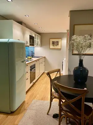 a kitchen with a table and a refrigerator at Rooftop Marina l by Madeira Best Apartments in Funchal