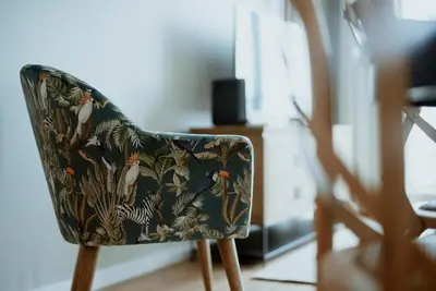a chair with a floral seat in a room at Rooftop Marina l by Madeira Best Apartments in Funchal