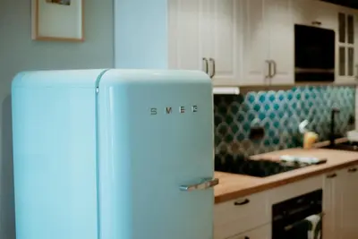 a blue refrigerator in a kitchen next to a counter at Rooftop Marina l by Madeira Best Apartments in Funchal