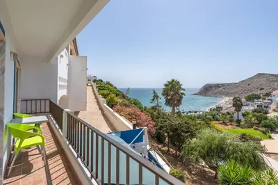 a balcony with a view of the ocean at Stunning sea view apartment in Burgau #1897 in Burgau