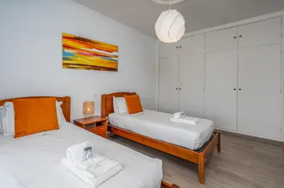 a bedroom with two beds and a painting on the wall at Stunning sea view apartment in Burgau #1897 in Burgau