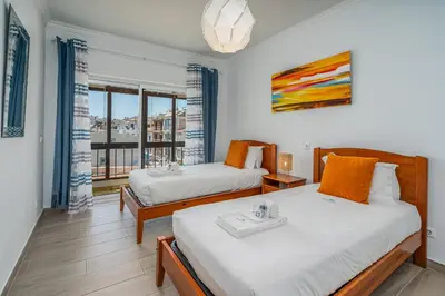 two beds in a room with a window at Stunning sea view apartment in Burgau #1897 in Burgau