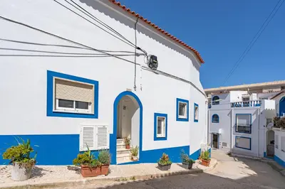 a blue and white building with a blue door at Stunning sea view apartment in Burgau #1897 in Burgau