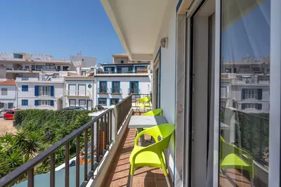 a balcony with a table and chairs and buildings at Stunning sea view apartment in Burgau #1897 in Burgau