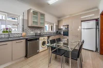 a kitchen with a glass table and a refrigerator at Stunning sea view apartment in Burgau #1897 in Burgau