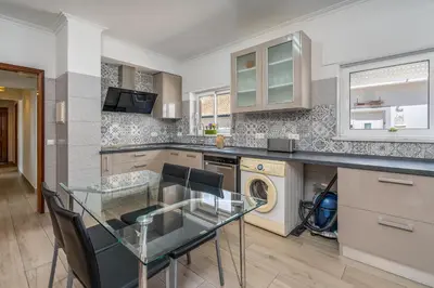 a kitchen with a glass table and a dishwasher at Stunning sea view apartment in Burgau #1897 in Burgau