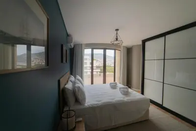 a bedroom with a bed and a large window at Rooftop Marina ll by Madeira Best Apartments in Funchal