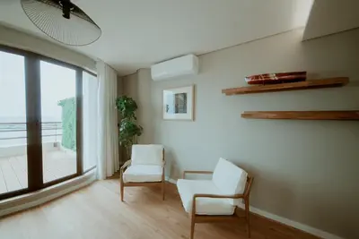 a living room with two chairs and a window at Rooftop Marina ll by Madeira Best Apartments in Funchal