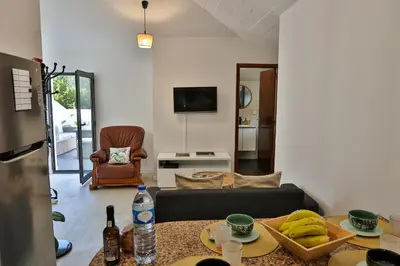 a living room with a couch and a table at Sebastian's Apartment in São Vicente