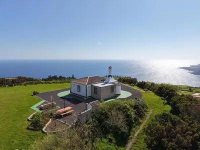 an aerial view of a lighthouse on a green field at Casita - Cantinho do Paraíso in Vila do Porto