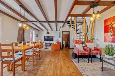 a dining room with a table and chairs at São Jorge Cottage - By WeHost in Santana