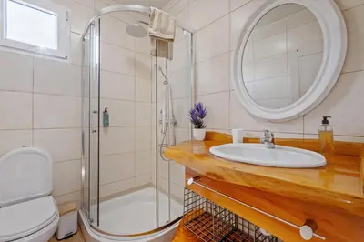 a bathroom with a sink and a shower at São Jorge Cottage - By WeHost in Santana