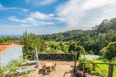 a view from the balcony of a house with a table and chairs at São Jorge Cottage - By WeHost in Santana