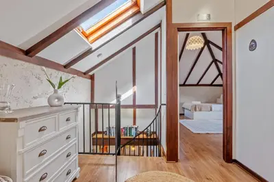 a room with a staircase leading to a bedroom at São Jorge Cottage - By WeHost in Santana