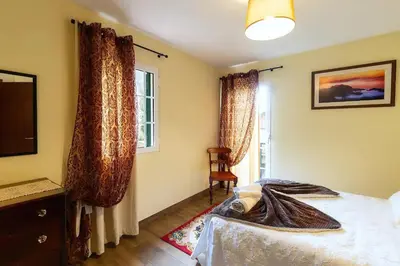 a bedroom with a bed with a towel on it at Villa Rústica - Casa da Lurdes in Ribeira Brava