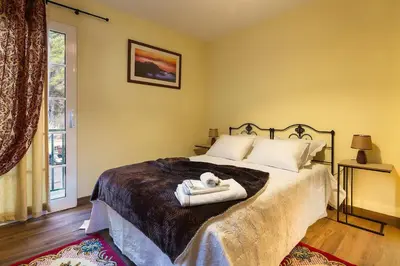 a hotel room with two beds and a dresser at Villa Rústica - Casa da Lurdes in Ribeira Brava