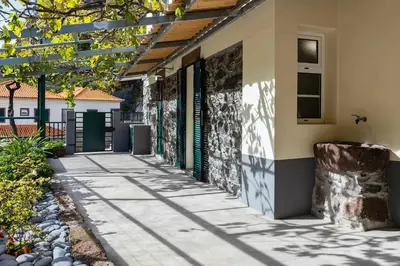 a walkway outside of a house with a building at Villa Rústica - Casa da Lurdes in Ribeira Brava