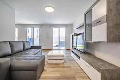 a living room with a couch and a flat screen tv at SolMar in Jardim do Mar