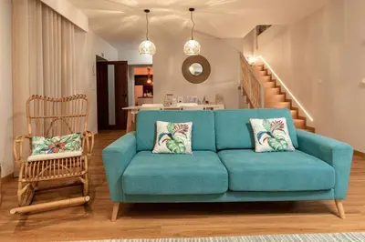 a living room with a blue couch and a table at Villa Sea - Rural Holiday Experience by SeaPearl in Paul do Mar