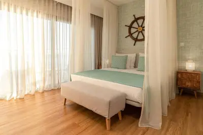 a mirror and some chandeliers on a wall at Villa Sea - Rural Holiday Experience by SeaPearl in Paul do Mar