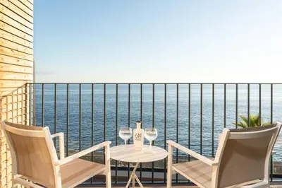 a bedroom with a bed and a balcony with a view at Villa Sea - Rural Holiday Experience by SeaPearl in Paul do Mar