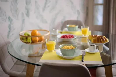 a glass table with breakfast foods and drinks on it at Mon Coin Dans La Ville by Homie in Funchal