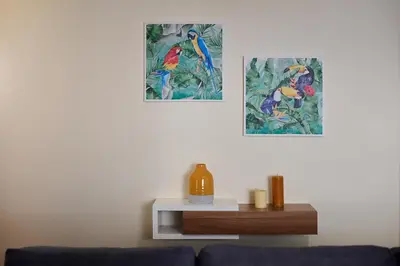 a living room with two pictures of birds on the wall at Mon Coin Dans La Ville by Homie in Funchal